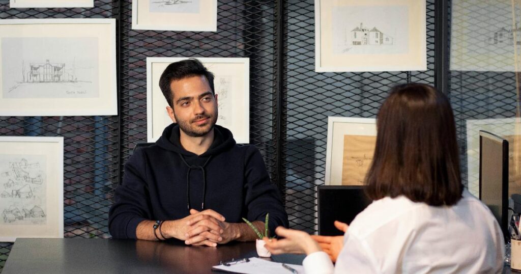 Founder reviewing a business hypothesis map and testing assumptions with customer interviews and simple experiments
