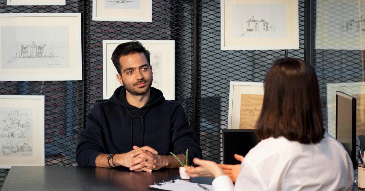 Founder reviewing a business hypothesis map and testing assumptions with customer interviews and simple experiments