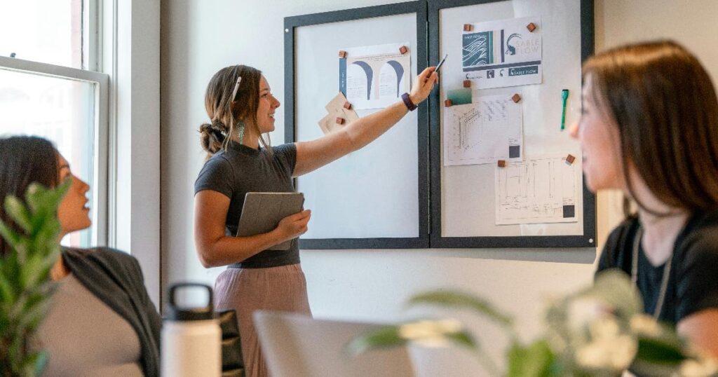 A team reviewing a workflow dashboard to validate an AI feature against baseline metrics