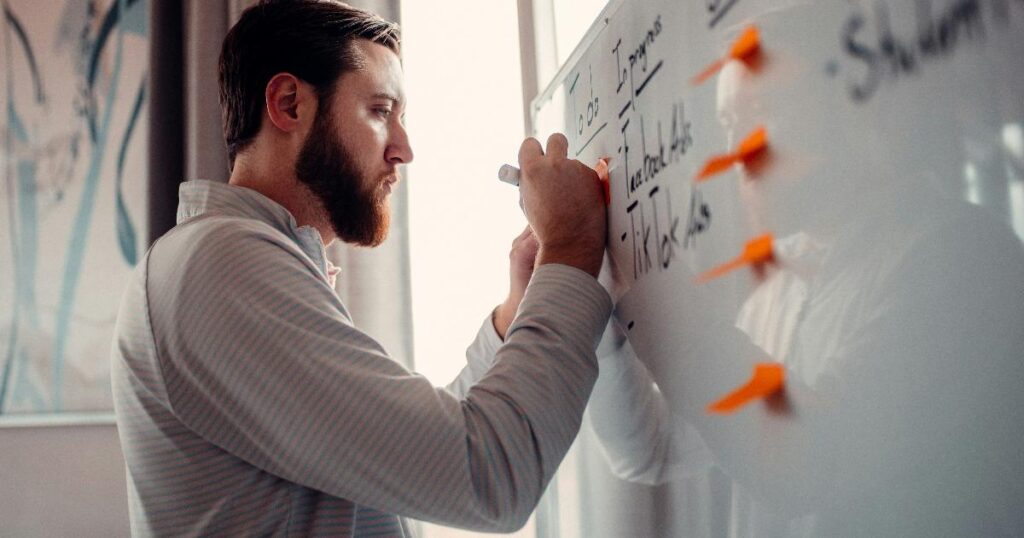 Founder reviewing a business plan as a hypothesis testing tool for customer demand, pricing, and costs