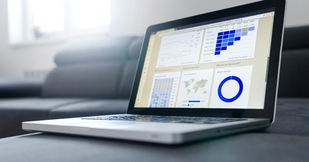 Founder reviewing shopping signals on a laptop with a funnel chart and customer notes