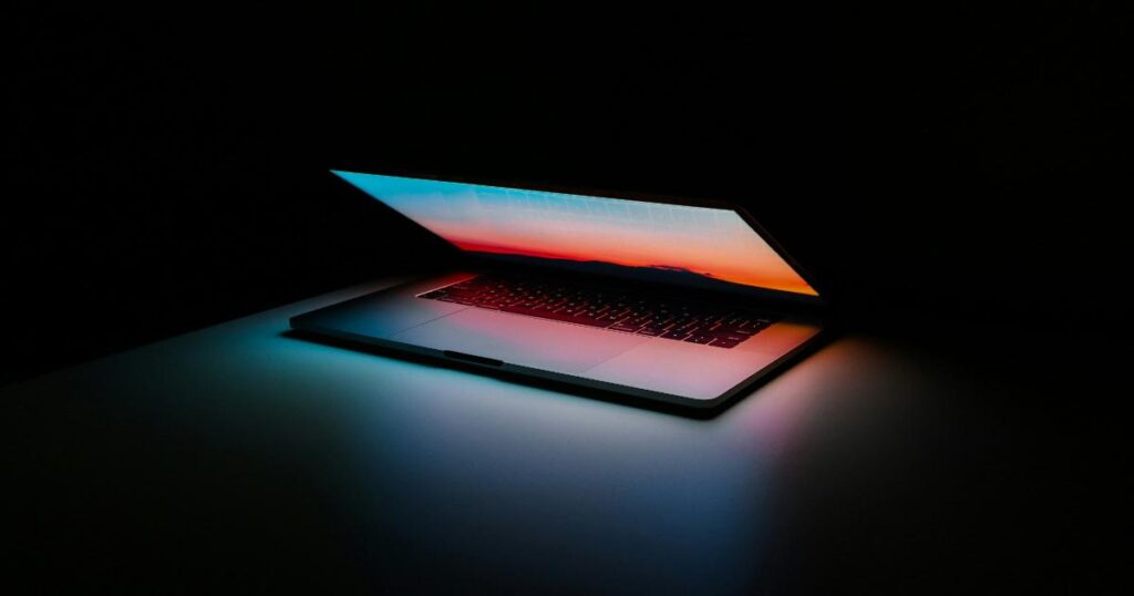 Founder reviewing a personal brand profile on a laptop, weighing trust signals against online reach