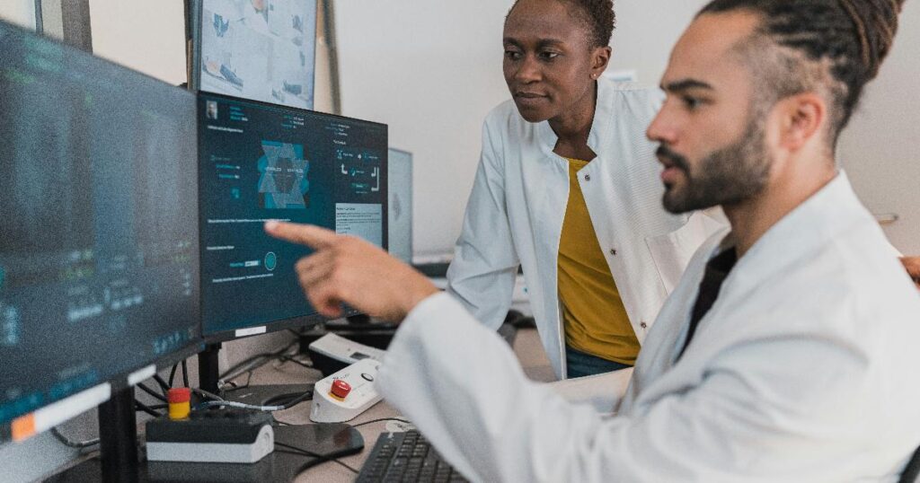 A small team reviews an AI pilot dashboard, highlighting the need for AI validation before rollout.