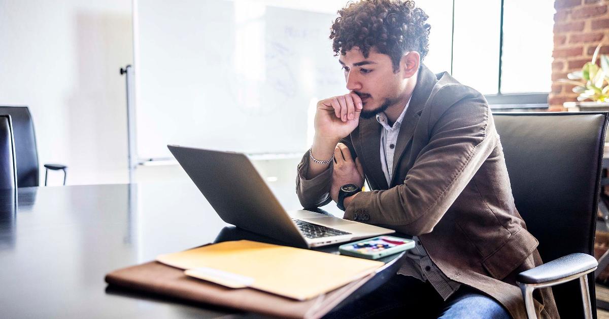 Burnt-out founder staring at a laptop, illustrating burnout as a signal problem and loss of judgment
