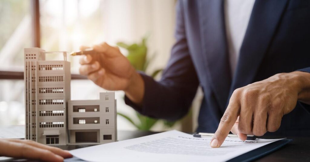 A real estate agent reviewing documents with a homebuyer, illustrating a real estate unbundling market signal