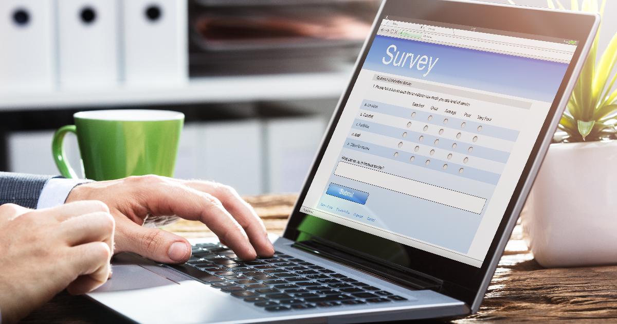 Researcher reviewing website survey responses on a laptop to identify bias and improve user experience