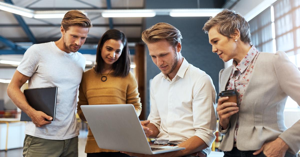 A startup team reviewing an interactive product demo on a laptop, using the demo as a demand experiment to study user behavior