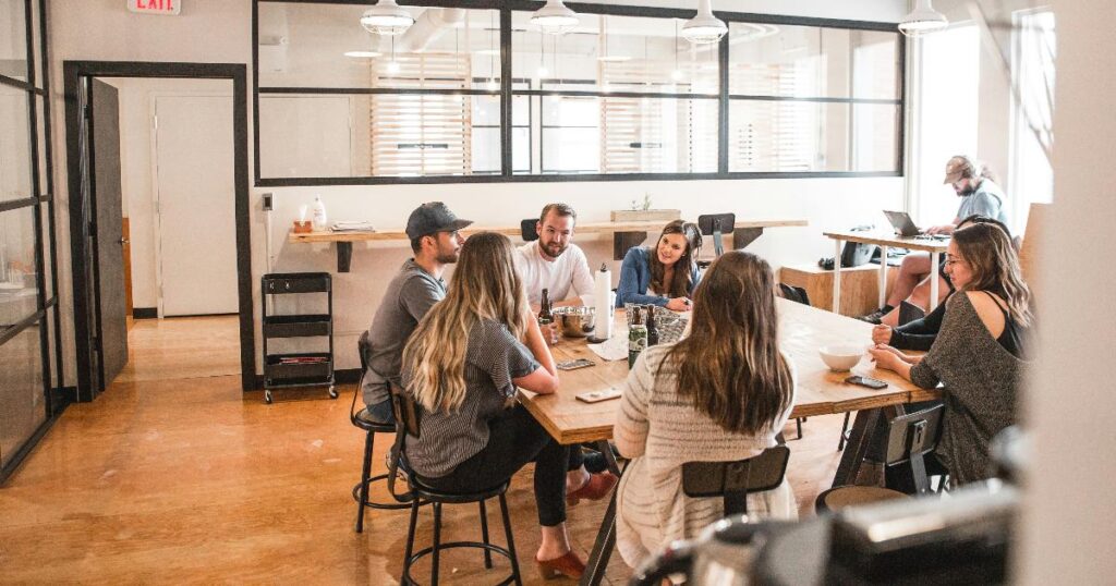 A founder reviewing team decisions at a desk, illustrating how a founder bottleneck can distort startup validation and slow learning