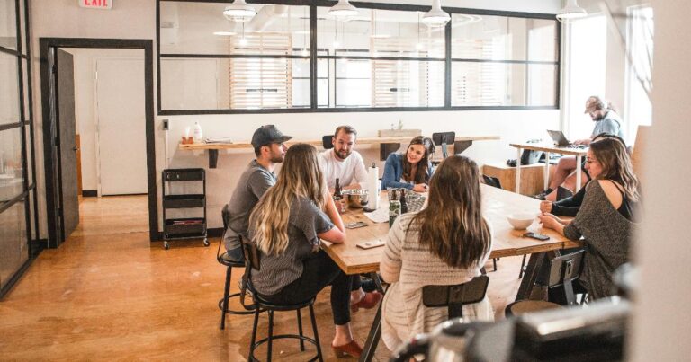 A founder reviewing team decisions at a desk, illustrating how a founder bottleneck can distort startup validation and slow learning